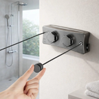Wall mounted retractable drying rack in modern bathroom with hand pulling cord