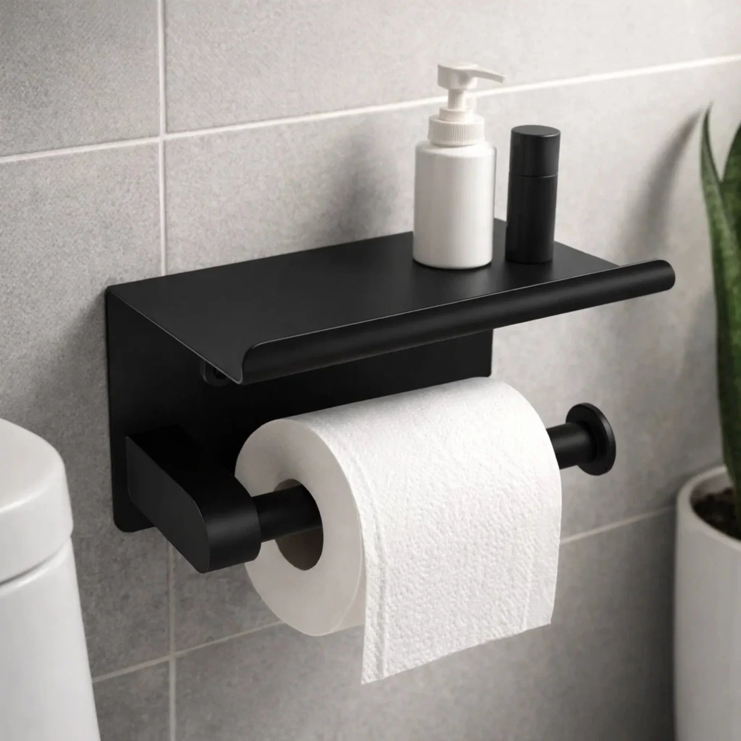 Black wall mounted toilet paper holder with shelf for soap dispenser in modern bathroom