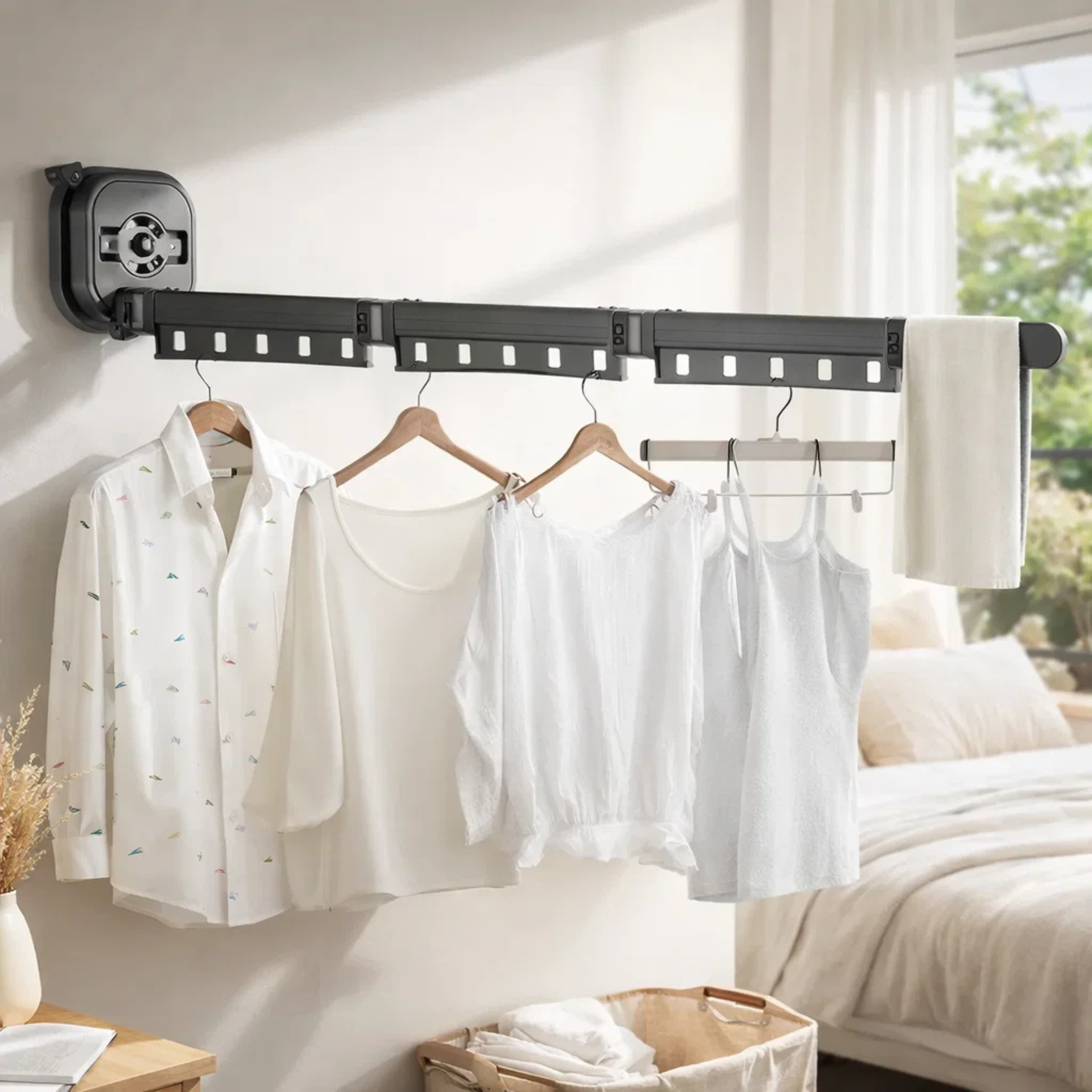 Wall mounted retractable drying rack with clothes and towel in a modern bedroom