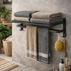 Wall mounted black towel rack with folded towels, hanging bath sponge and brush in modern bathroom